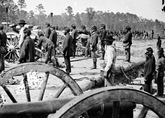 Union soldiers getting into position behind their weapons ready for an attack