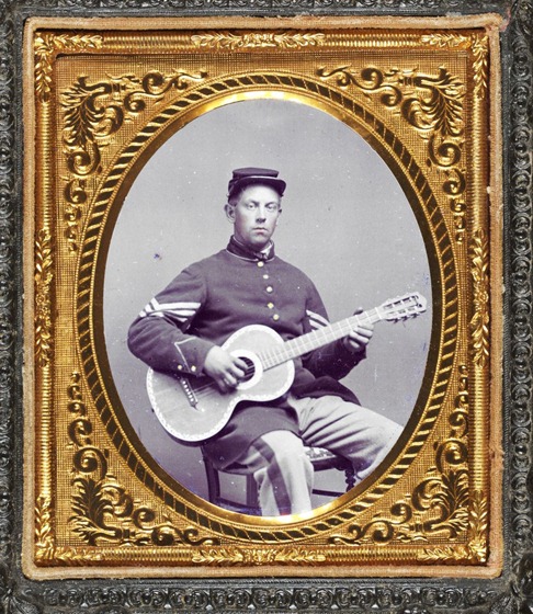 Edwin Chamberlain of Company G, 11th New Hampshire Infantry in sergeant's uniform with guitar