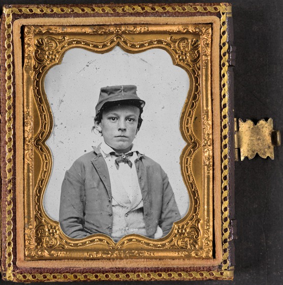 Unidentified young soldier in Confederate infantry uniform, possibly drummer boy