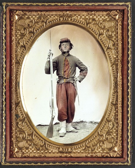 soldier in Union zouave uniform with bayoneted musket with initials A.T. on stock