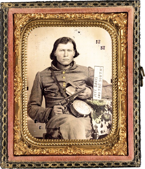 Thomas Isaiah Booker in Confederate uniform with Colt navy revolver, book, tin drum canteen, and sign reading Jeff Davis and the South!