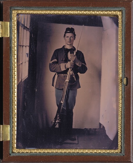 Unidentified soldier in Union uniform with M1816 conversion musket with affixed bayonet, bowie knife, and large Colt revolver