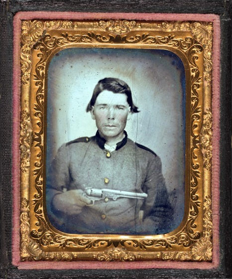 Unidentified soldier in Confederate uniform with Colt revolver in photo case