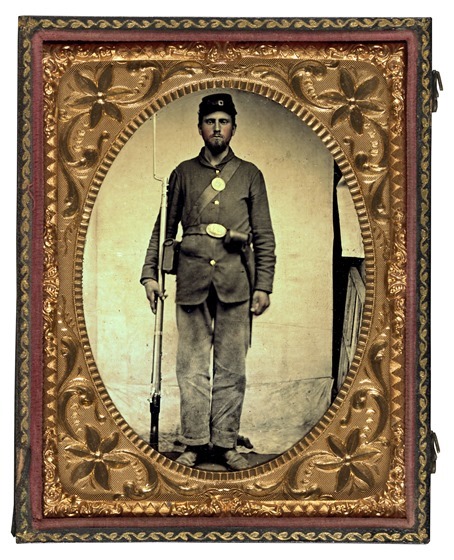 Unidentified soldier in Union uniform with bayoneted musket, cartridge box, and cap box2 in photo case