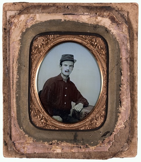 Unidentified soldier in red battleshirt and kepi in picture frame