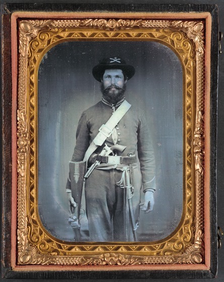 Unidentified cavalry soldier in Union uniform with Sharps carbine rifle, Colt revolver, and cavalry saber -- in case