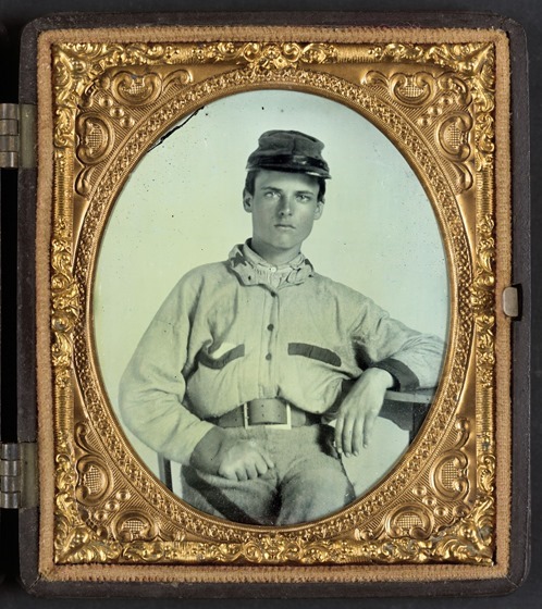 Unidentified soldier in Confederate battleshirt, kepi, and wishbone belt buckle -- in frame