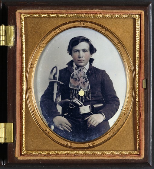 Unidentified soldier in Confederate uniform with cavalry sword and revolver -- in frame