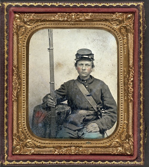 Unidentified young soldier in Union uniform with musket and bayonet in scabbard in case